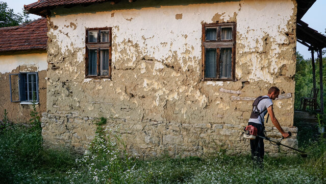 Worker cuts weeds 