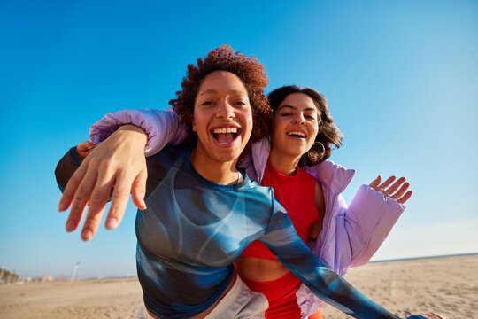 Cheerful black women taking selfie on beach - Powered by Adobe