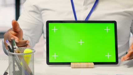 Expert shows tablet with mockup chroma key to mature couple in office, meeting for a counseling...