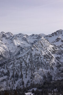 The mountains are covered in snow and the sky is clear