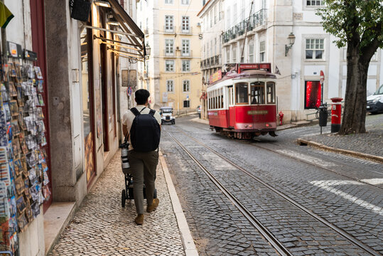 Tourist walking on lisbon sidewalk