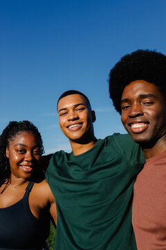 Portrait of diverse group of healthy friends posing happily in a Park