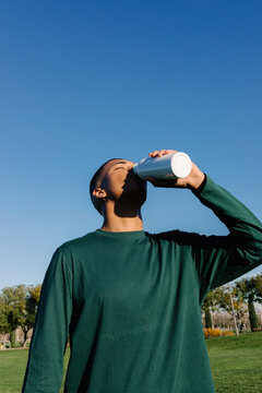 Man quenches their thirst using a sustainable flask