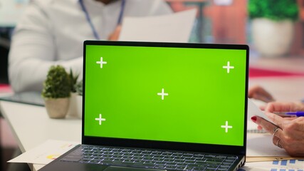 Old couple exploring financial retirement options with advisor next to green screen on laptop in modern office. Senior people receive counseling from broker about a retirement plan. Camera A.