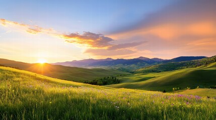 Fototapeta premium A serene mountain backdrop featuring rolling green hills, scattered wildflowers, and a vibrant sunset painting the sky.