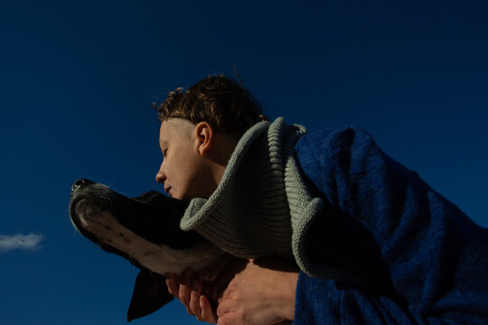 A girl with her dog in the blue sky 