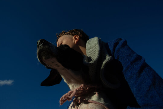 A girl with her dog in the blue sky 