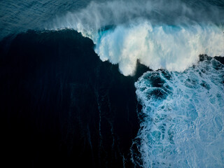 Top down aerial view of moody blue ocean wave