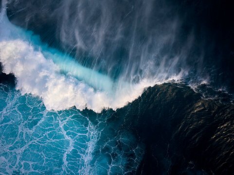 Top down aerial view of moody blue ocean wave