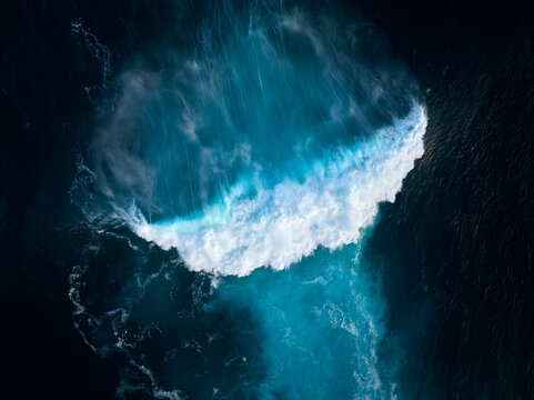 Top down aerial view of moody blue ocean wave