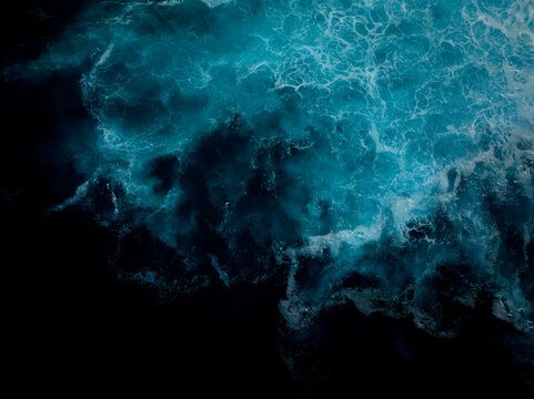Top down aerial view of moody blue ocean wave