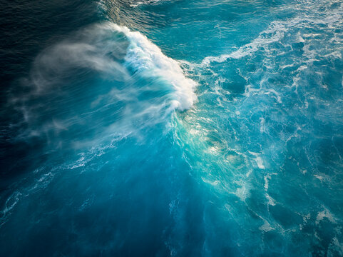 Top down aerial view of moody blue ocean wave