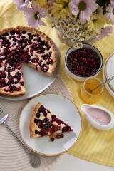 Delicious currant pie and fresh berries on white table, above view