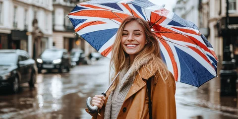 Fototapete Fotos Young beautiful smiling woman with open umbrella with pattern of British flag. Creative concept of language courses, English learning, traveling  © SnowElf