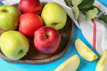 Fresh red and green apples on light blue wooden table