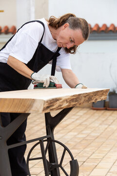 A carpenter sanding wood