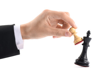 Man with white pawn knocking over chess king on white background, closeup. Competition concept