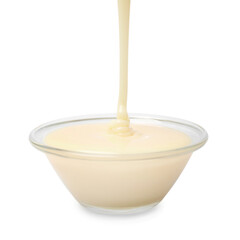 Pouring condensed milk into bowl isolated on white