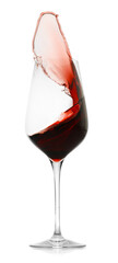 Red wine splashing in glass on white background