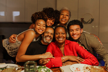 Happy family embracing and smiling during christmas dinner