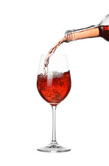 Pouring wine into glass on white background