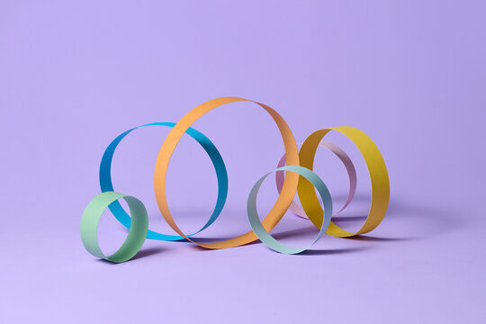 Colorful Paper Loops on Purple Background for Abstract Design