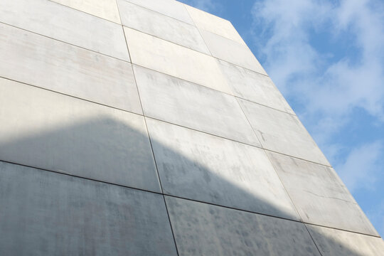 Grey stone concrete architecture wall with clear blue sky in city