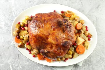 Delicious baked turkey, vegetables and cranberries on gray textured table, top view
