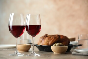 Red wine and delicious dinner served on wooden table