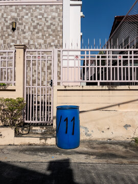 Blue recycle bin spray painted with the number eleven