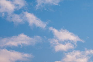 Fototapeta premium Soft white clouds drift across a vibrant blue sky creating a serene and peaceful atmosphere