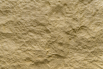 Yellow material texture with a rough and irregular wavy appearance