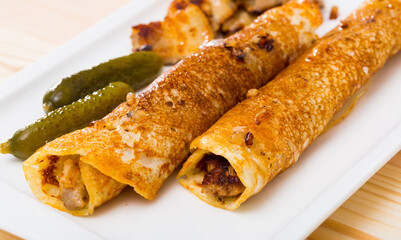 Close-up of delicious pancakes stuffed with fried chicken breast served on plate