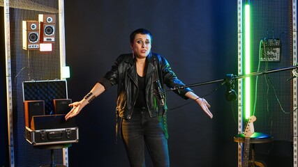 Heavy metal performer acting uncertain and shrugging in doubt, being clueless and uncertain about...