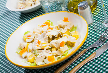 Delicious dietary salad of chicken breast, sweet pineapple, quail eggs and fresh lettuce