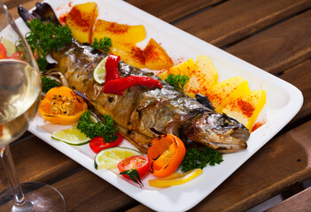 Whole roasted trout with grilled vegetables, parsley and lime