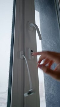 Opening a Window with a Child Lock. Home Safety and Child Protection. Closeup
