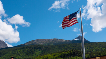 Landscape panorama. Scenic landscape with mountain in nature. Travel destination. Alaska mountain peak view. American flag. Mountain landscape with American flag, copy space