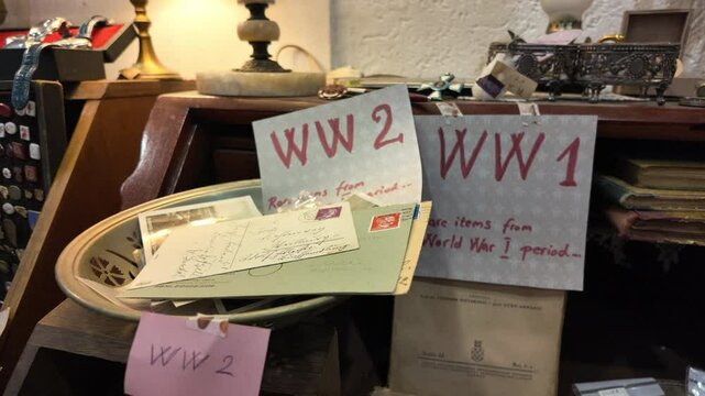 Close-up view of rare historical items and postcards from World War I and World War II displayed in an antique shop. Concept of vintage collectibles and historical documentation