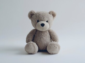 Obraz premium Photo of a cute teddy bear sitting on a white background, facing the camera. 