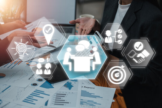 Business professionals discussing strategy with digital consulting icons overlay, symbolizing teamwork and innovation.