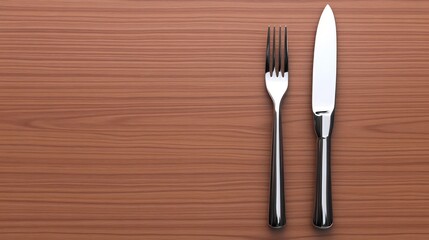 A knife and fork placed on a wooden table surface.