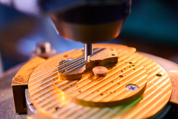 Precision milling of clockwork casing in a manufacturing workshop showcasing intricate design and technology
