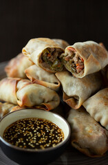 Tray of Stacked Egg Rolls with sesame dipping sauce