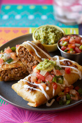 Tex-Mex Restaurant Chile Con Queso Dip in cast iron skillet with guacamole, salsa and tortilla chips