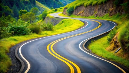 Fototapeta premium A winding road with a yellow line on the right side, curving around a bend in the landscape