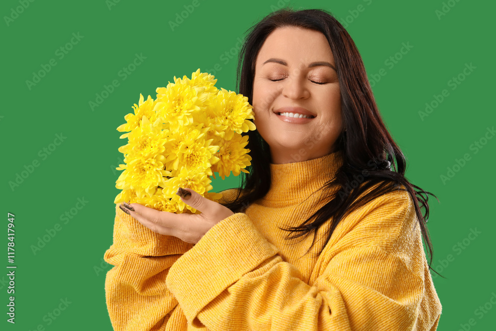 Wall mural Beautiful happy mature woman with bouquet of flowers on green background. International Women's Day