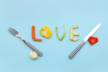 Word LOVE made of sliced vegetables and cutlery on color background