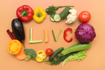 Composition with word LIVE and different fresh vegetables on color background