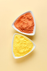 Plates with bright powder pigments on color background